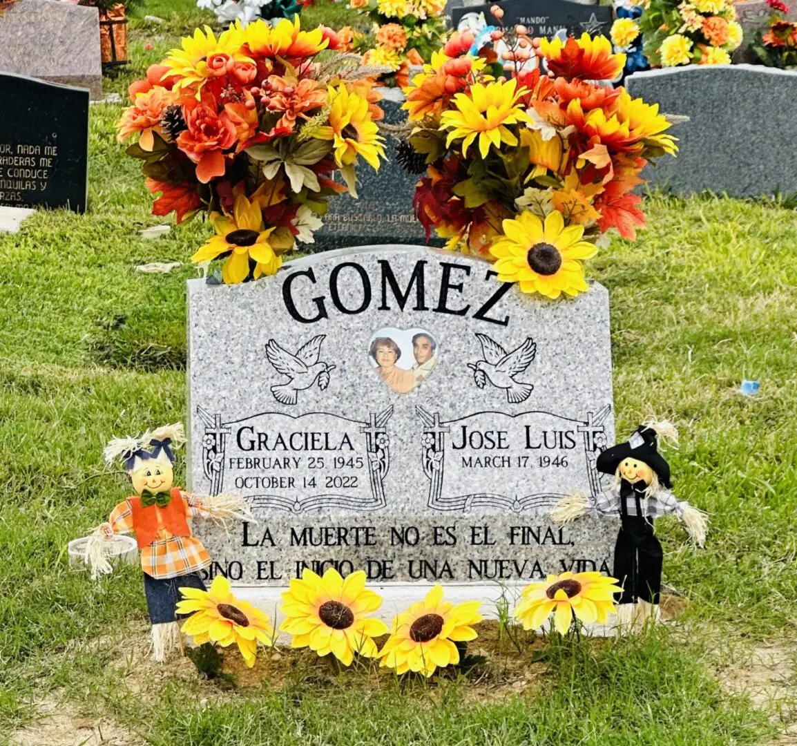 A grave stone with flowers on it.