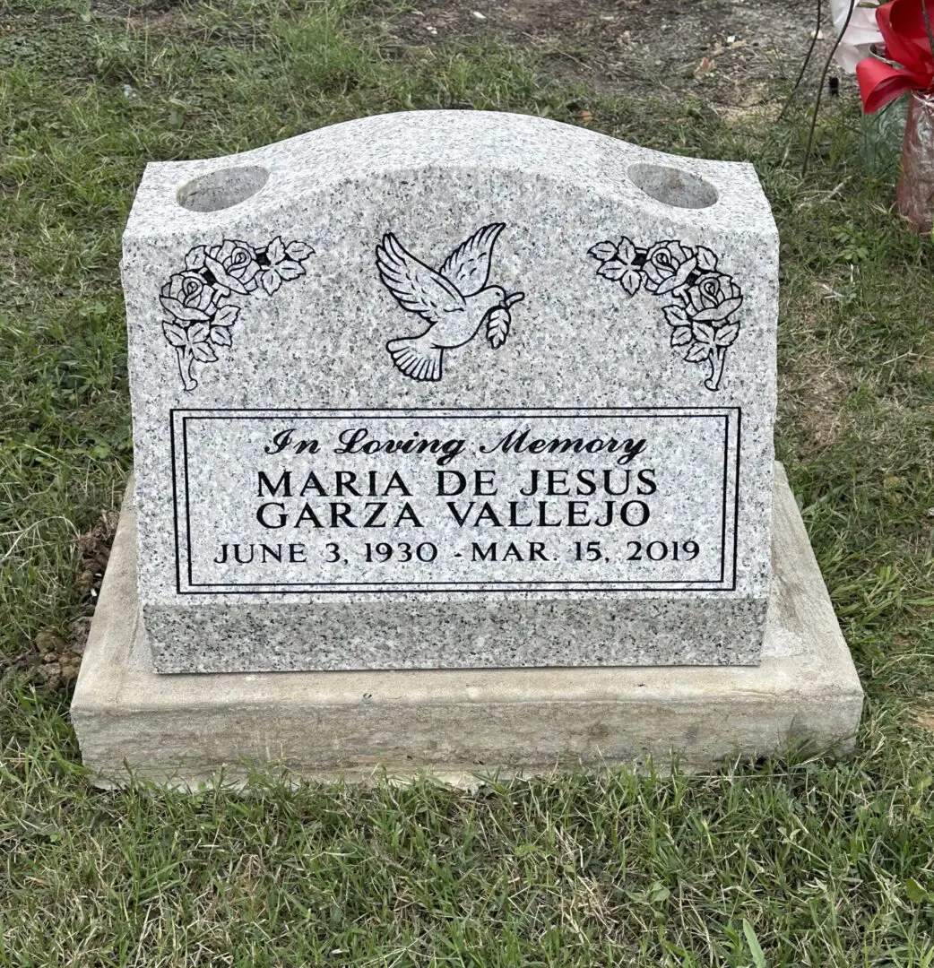 A grave stone with a bird on it.