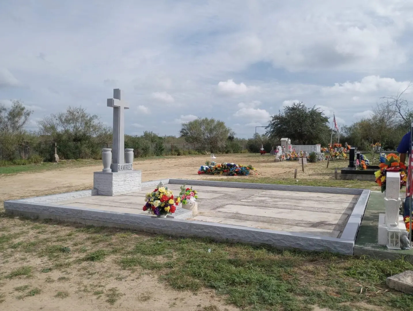 A cemetery with a cross in the middle of it.