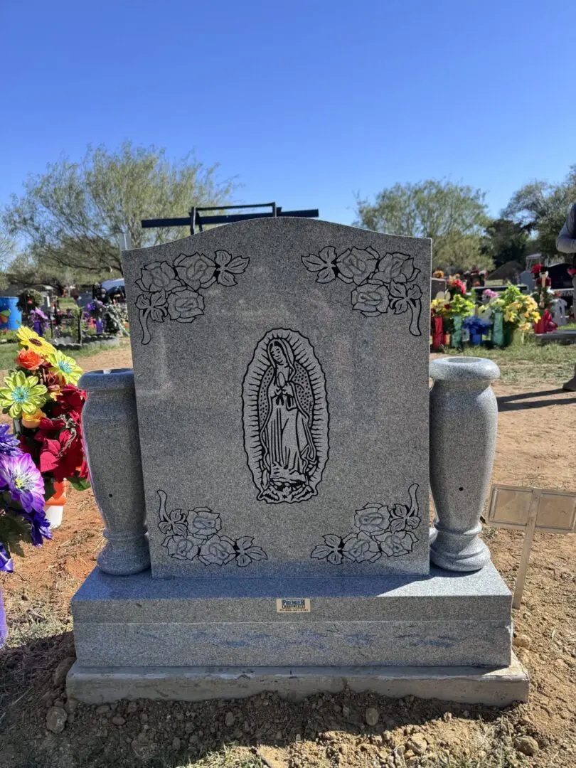 A gravestone with a statue of guadalupe.